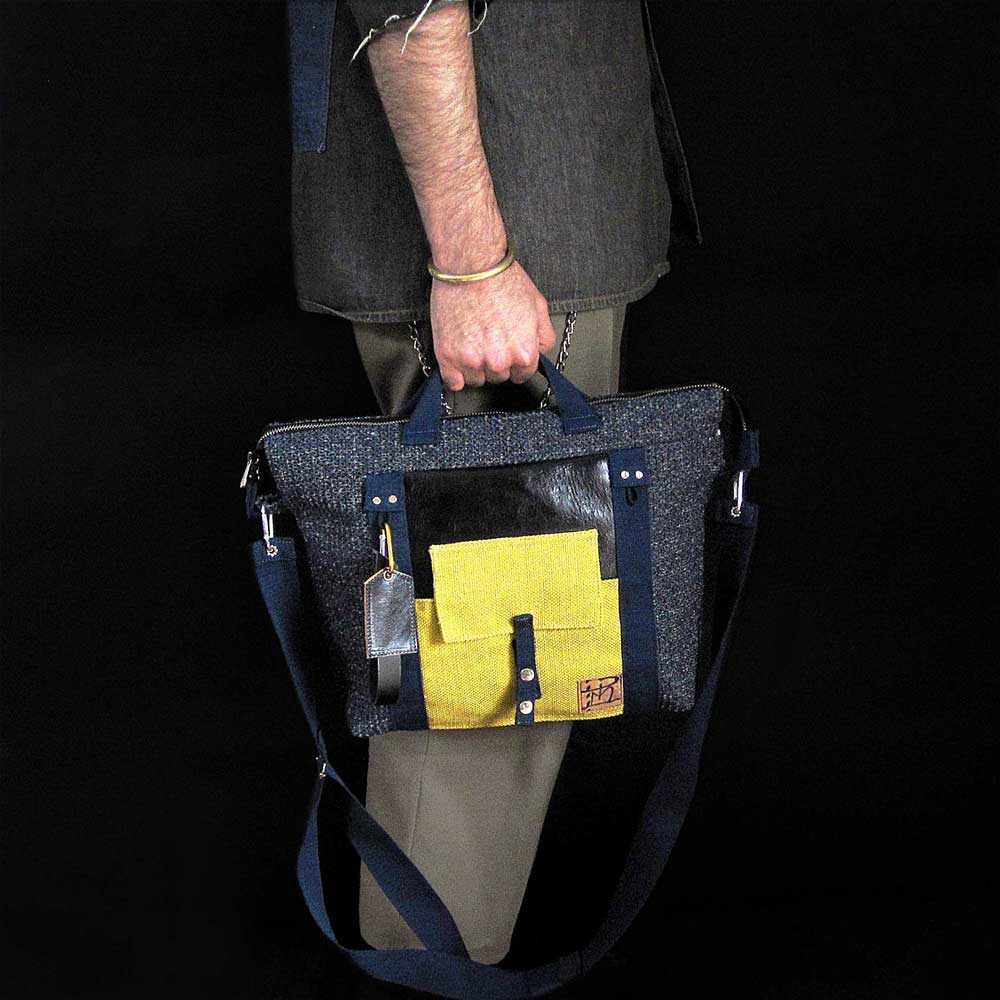 nuntia briefcase in industrial-chic palette carried by hand